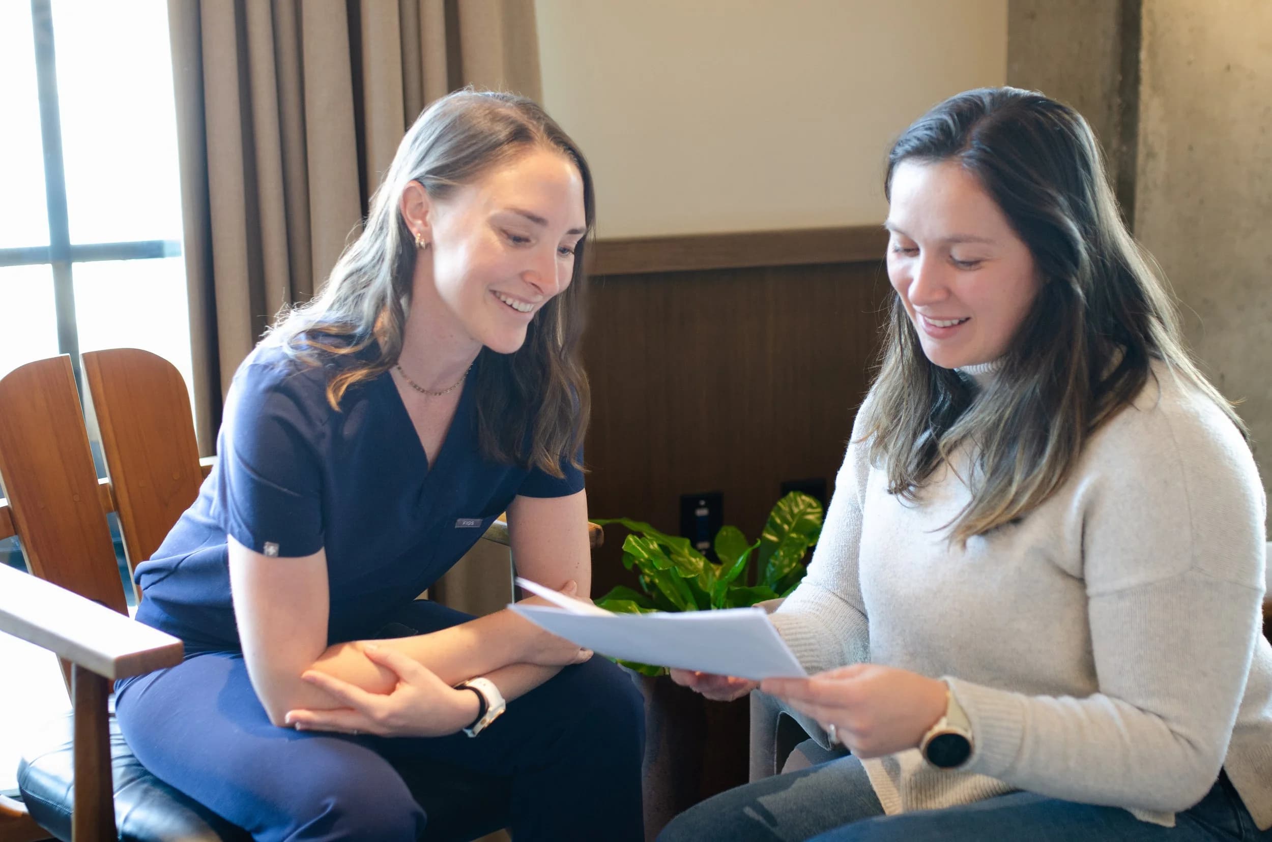 A nurse coaching a client through their first at-home injection