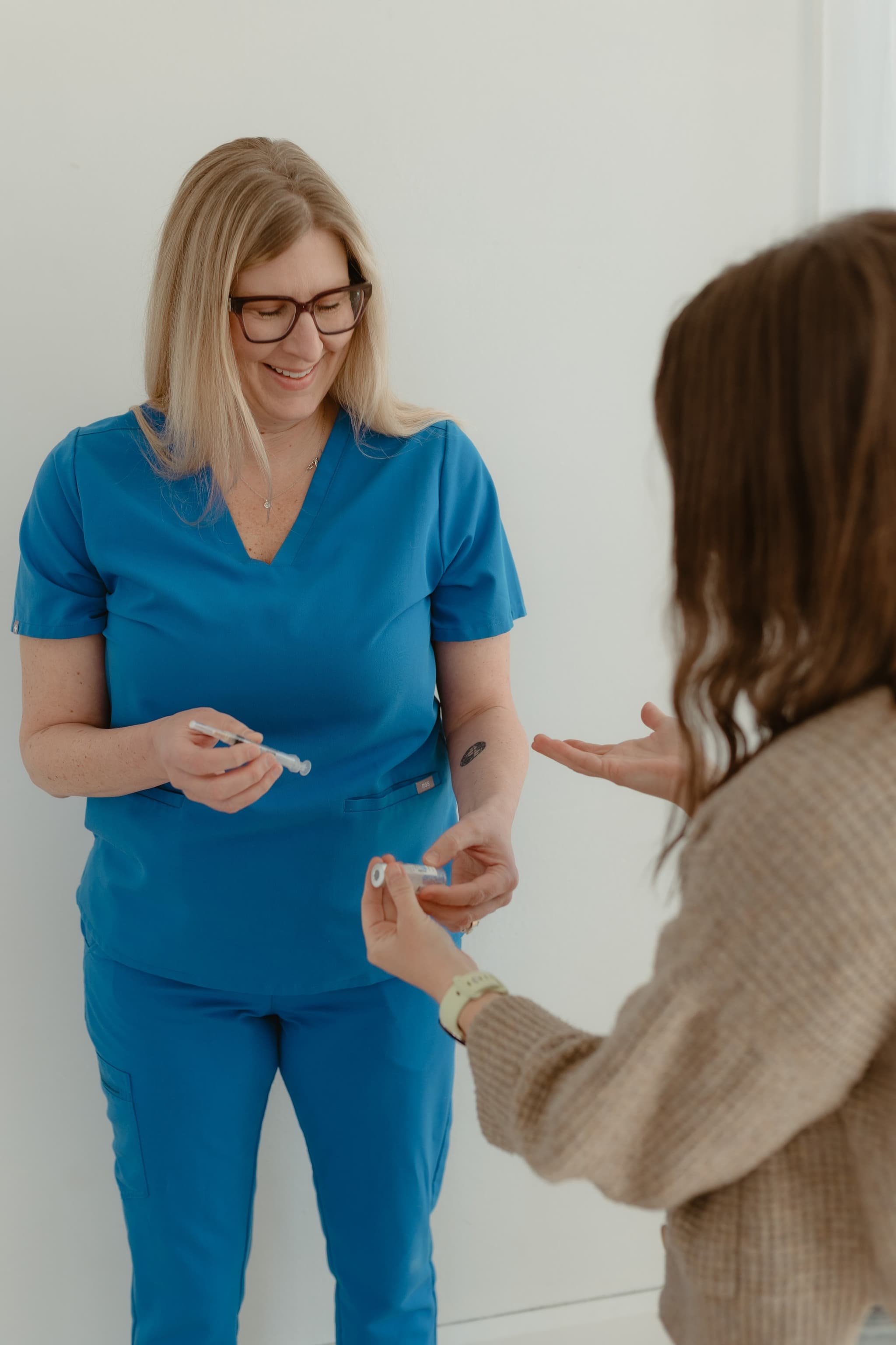 A Luna nurse coaching a client through a fertility injection